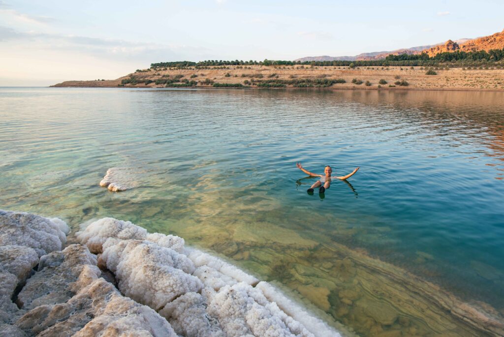 A male tourist relaxes in the water of the Dead Sea
