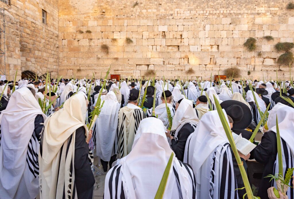 people praying at the western wall during sukkot in jerusalem
