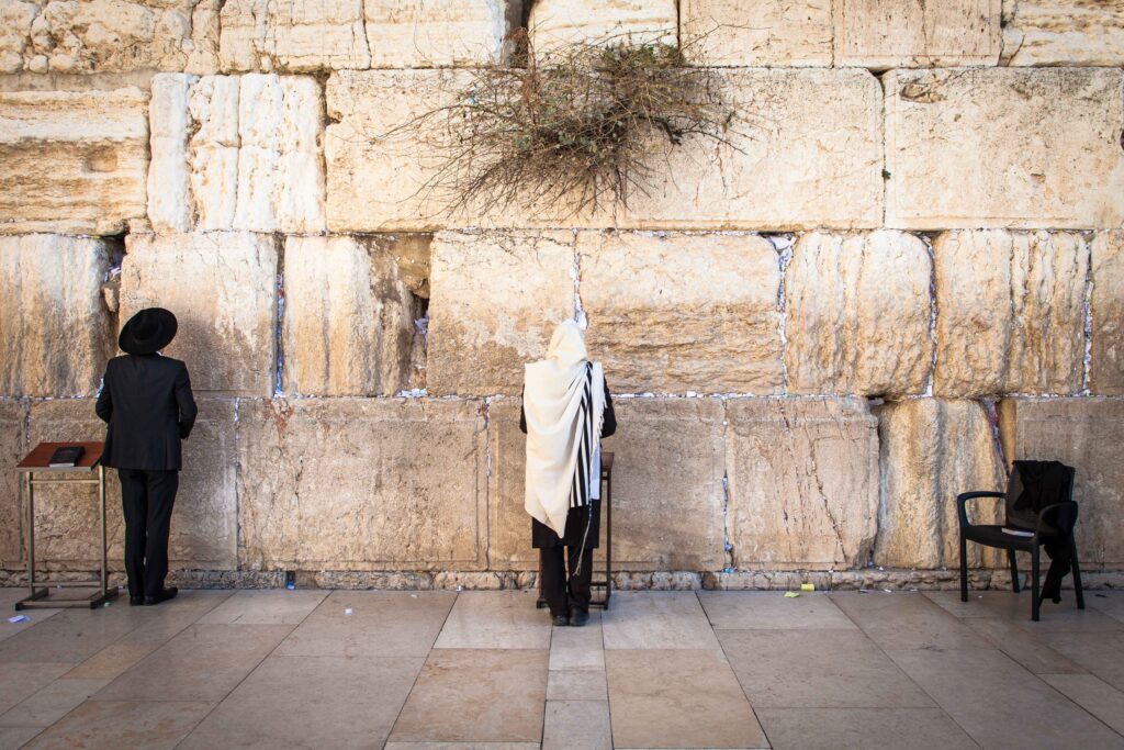 two jewish men praying at the western wall in the old city of jerusalem
